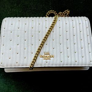 Coach white leather crossbody bag with a gold chain and gold accents!